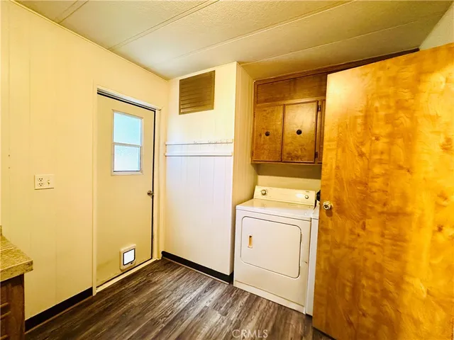 a view of a hallway with wooden floor and closet