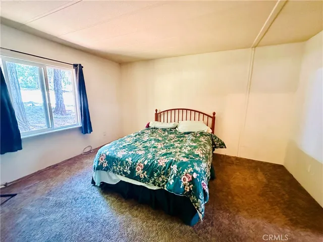 a bed sitting in a bedroom next to a window