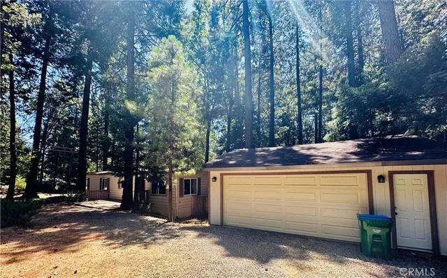 a view of a backyard with a tree