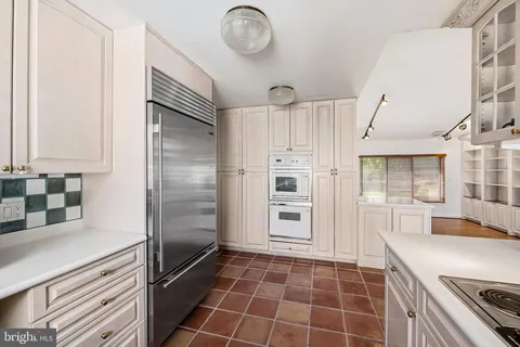 a kitchen with granite countertop a refrigerator and a sink