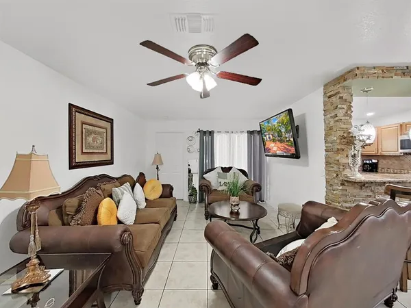 a living room with furniture and a ceiling fan