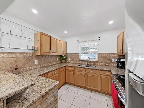 a kitchen with a sink stove and cabinets