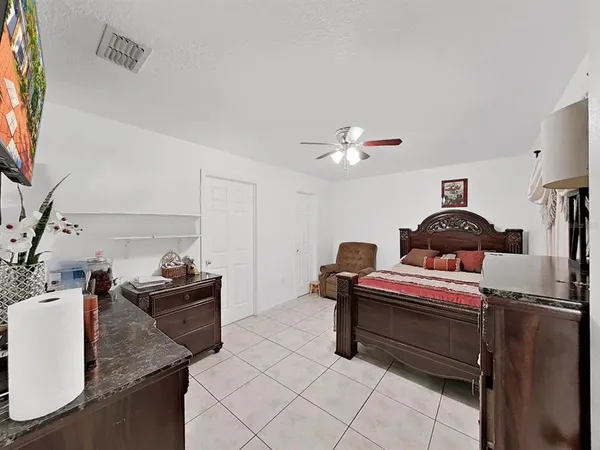 a bedroom with a bed and cabinets