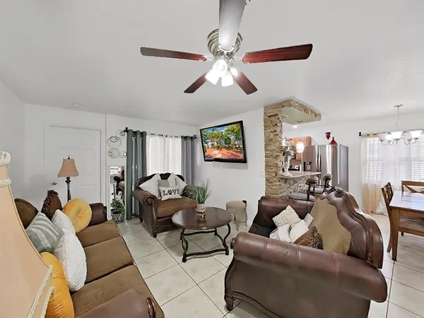 a living room with furniture and a chandelier
