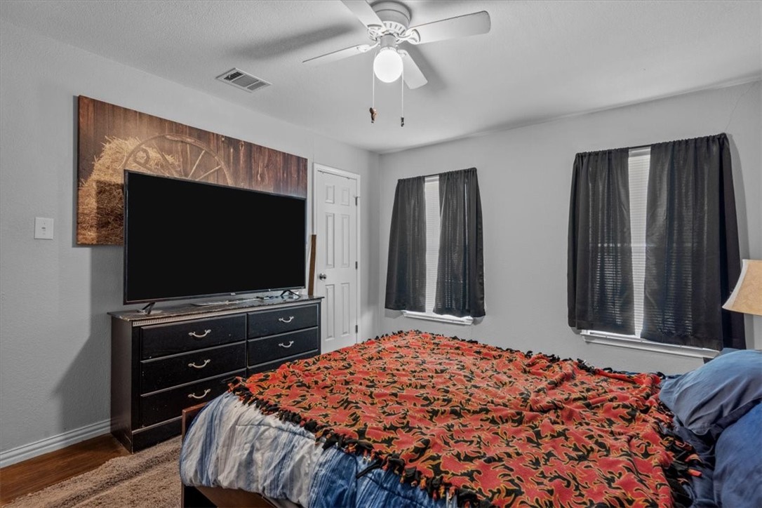 502 Bales Street Cleburne, TX 76033 - Photo 15 of 20 a bedroom with bed and flat screen tv