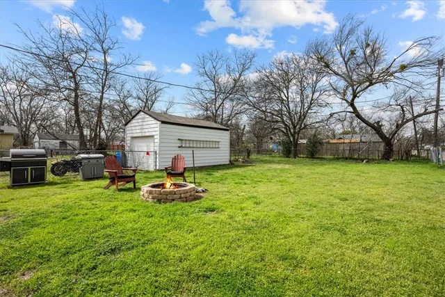 a front view of house with yard and trees