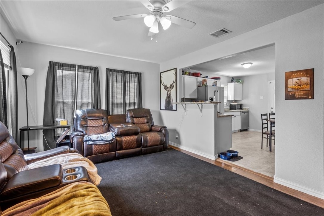 502 Bales Street Cleburne, TX 76033 - Photo 5 of 20 a living room with furniture and a chandelier