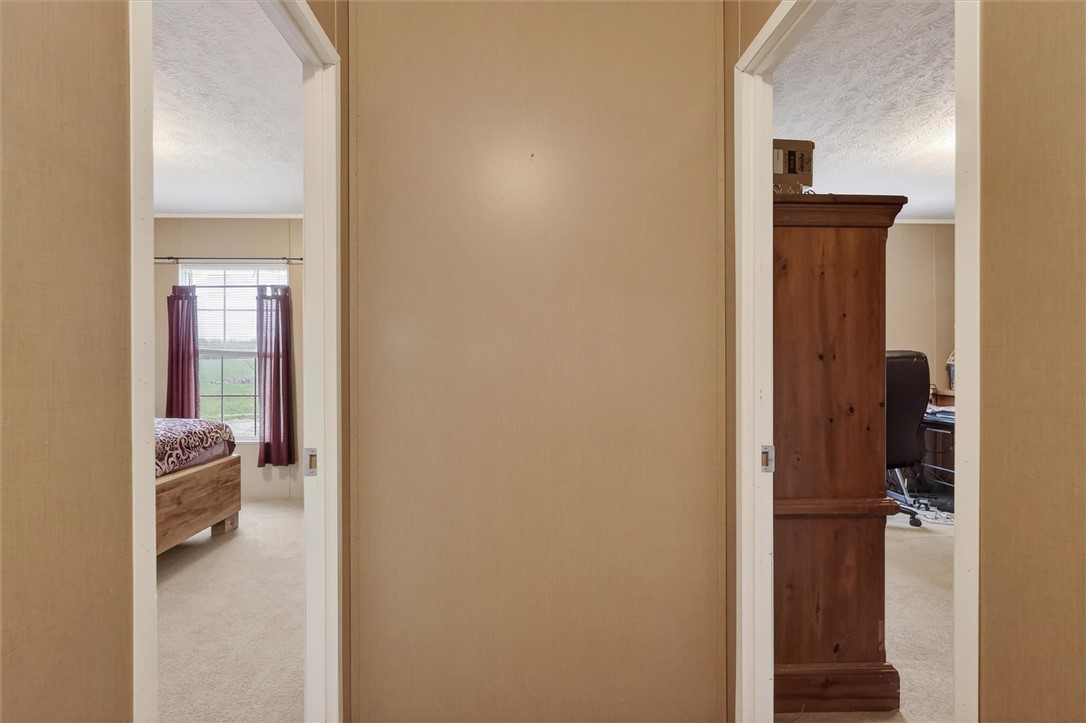 1926 Fairview Road Peebles, OH 45660 - Photo 26 of 44 This interior hallway connects to a comfortable bedroom and a dedicated office space.