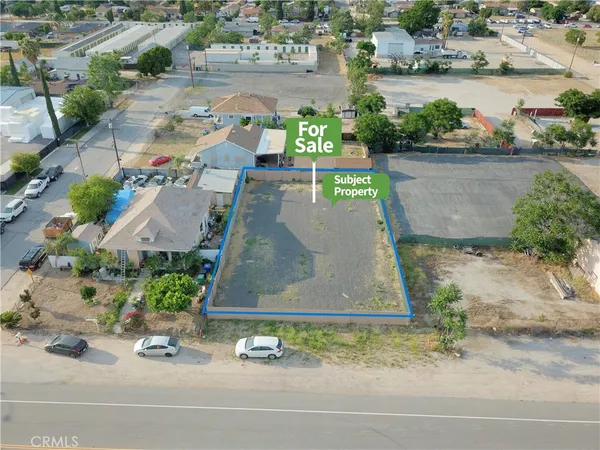 an aerial view of a house with a yard and lake view