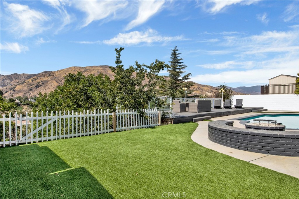 12036 Darby Avenue Porter Ranch, CA 91326 - Photo 11 of 37 a swimming pool with wooden fence