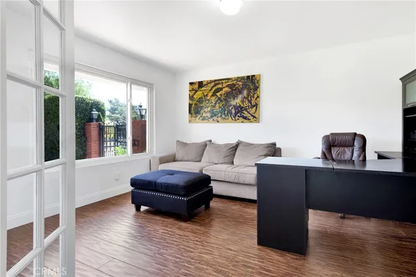 a living room with furniture and wooden floor