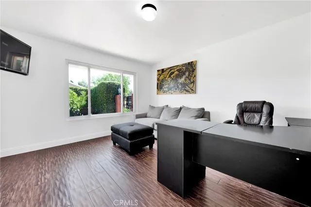 a kitchen with stainless steel appliances kitchen island granite countertop a table chairs in it and wooden floors