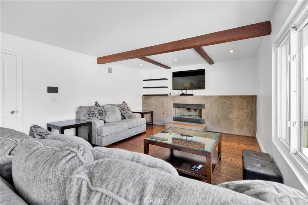 12036 Darby Avenue Porter Ranch, CA 91326 - Photo 24 of 37 a living room with furniture and a flat screen tv
