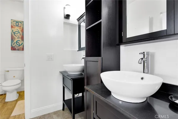 a bathroom with a sink toilet and a mirror