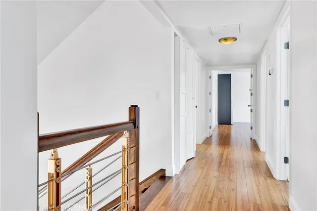 a large bed sitting in a bedroom next to a window