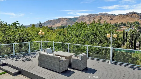 a view of a balcony with chairs