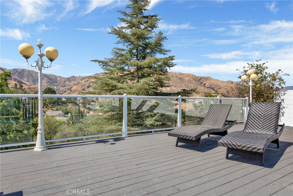 12036 Darby Avenue Porter Ranch, CA 91326 - Photo 3 of 37 a view of a balcony with chairs
