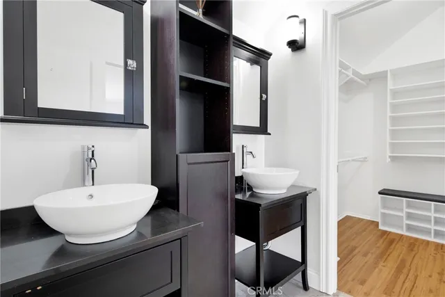 a bathroom with a sink toilet and a mirror