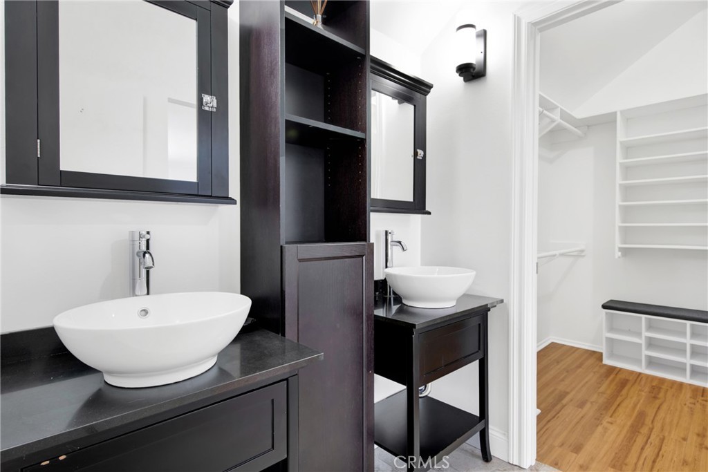 12036 Darby Avenue Porter Ranch, CA 91326 - Photo 33 of 37 a bathroom with a sink a mirror and a toilet