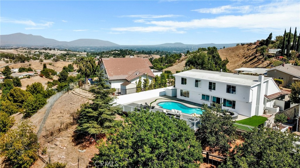 12036 Darby Avenue Porter Ranch, CA 91326 - Photo 4 of 37 a view of a white house with a yard and sitting area