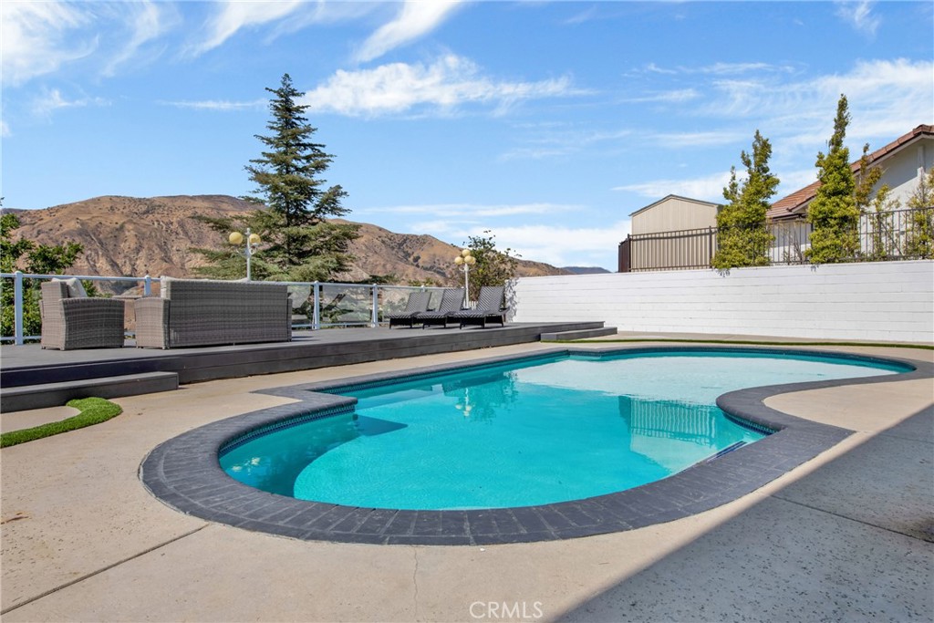 12036 Darby Avenue Porter Ranch, CA 91326 - Photo 7 of 37 a view of a swimming pool with a patio