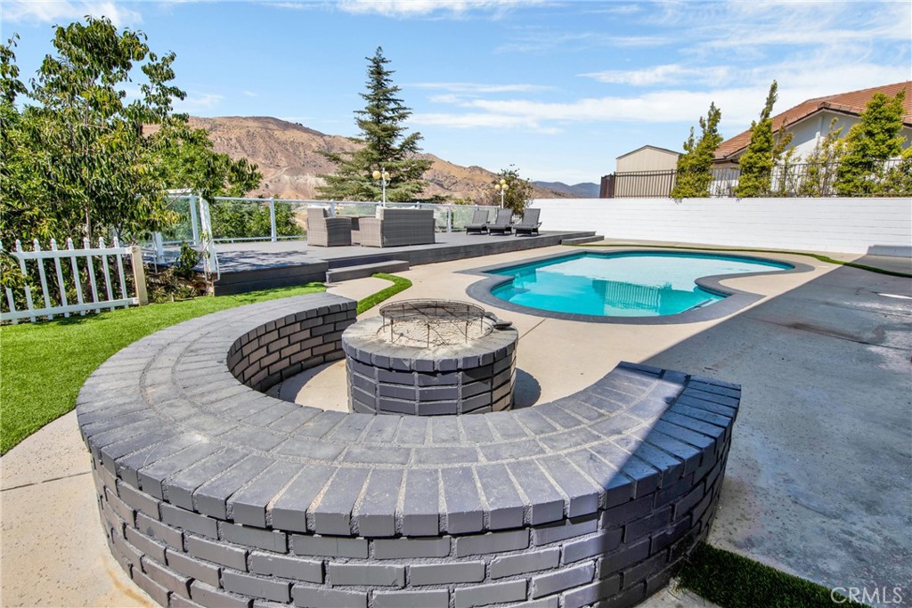 12036 Darby Avenue Porter Ranch, CA 91326 - Photo 9 of 37 a view of a swimming pool with a back yard