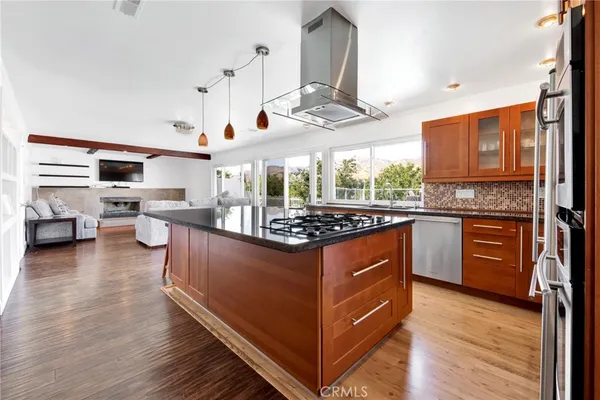 a kitchen with stainless steel appliances granite countertop a stove and a refrigerator