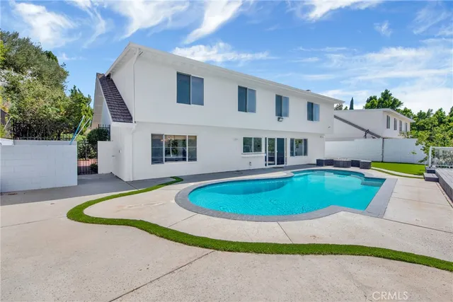 a swimming pool with wooden fence