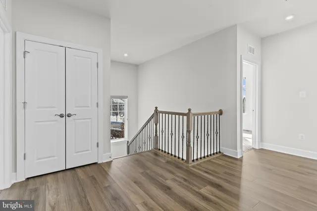 an empty room with windows and entrance