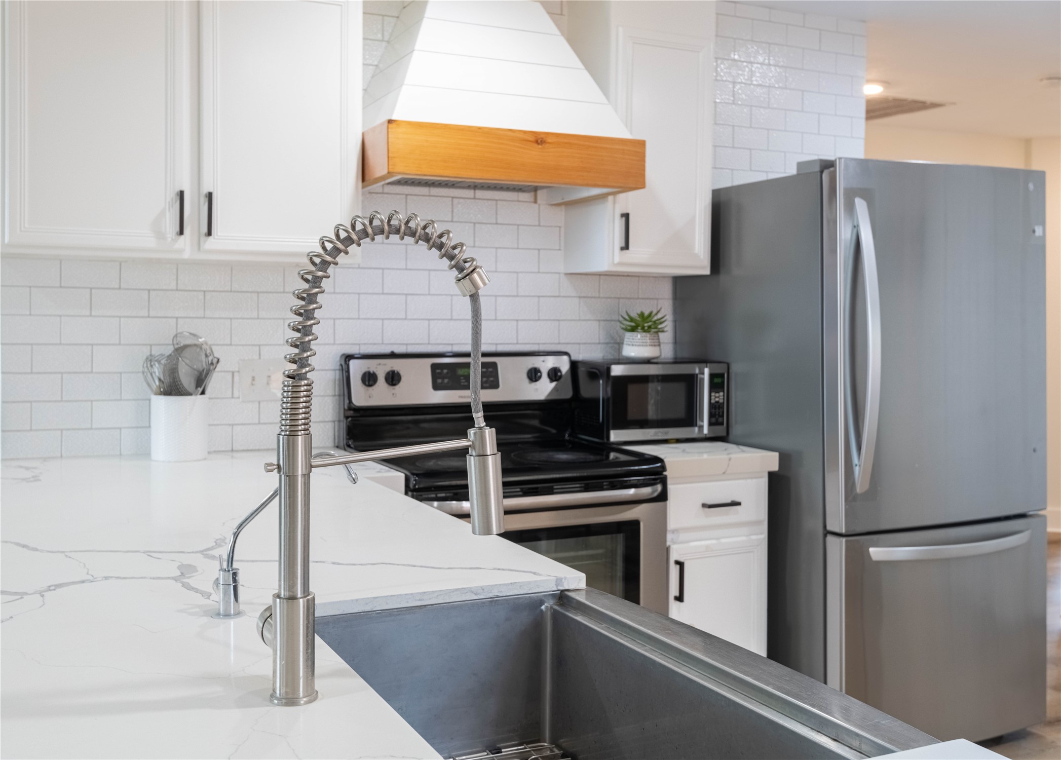 2031 7th Street Hempstead, TX 77445 - Photo 11 of 30 a kitchen with stainless steel appliances a refrigerator and a stove