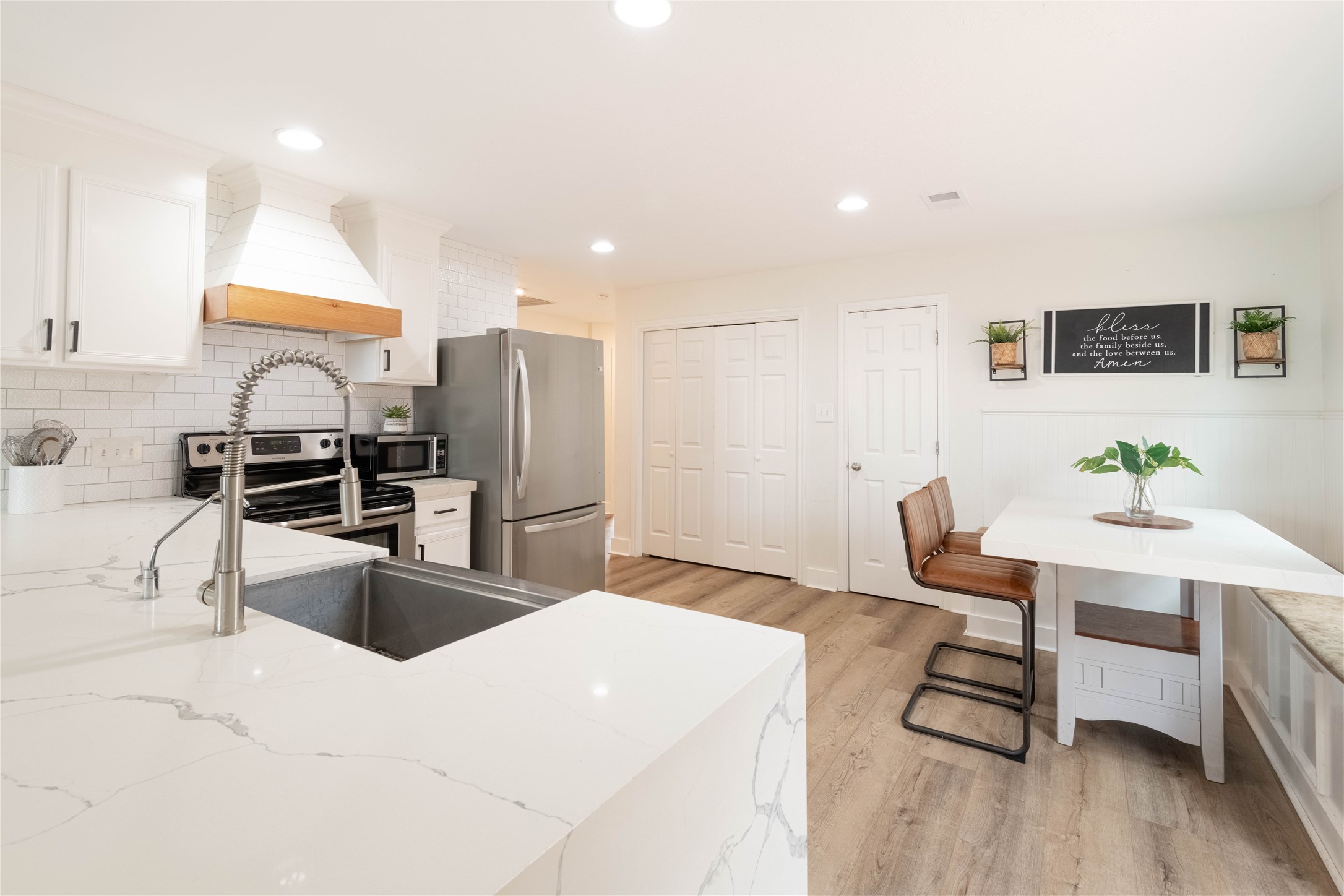 2031 7th Street Hempstead, TX 77445 - Photo 9 of 30 a kitchen with stainless steel appliances kitchen island granite countertop a sink refrigerator and cabinets