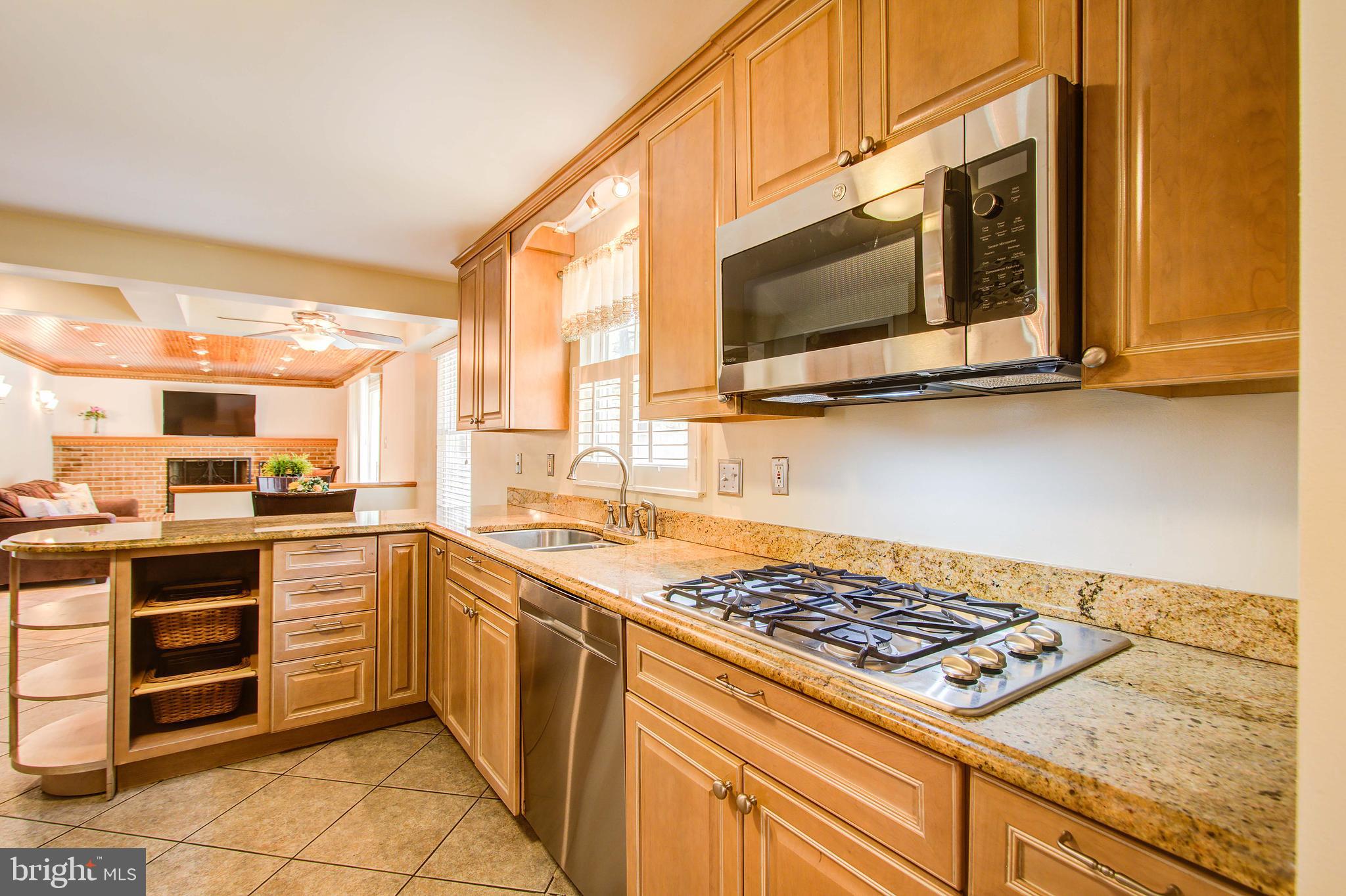 1413 Rainbow Drive Silver Spring, MD 20905 - Photo 12 of 50 a kitchen with a stove and a microwave
