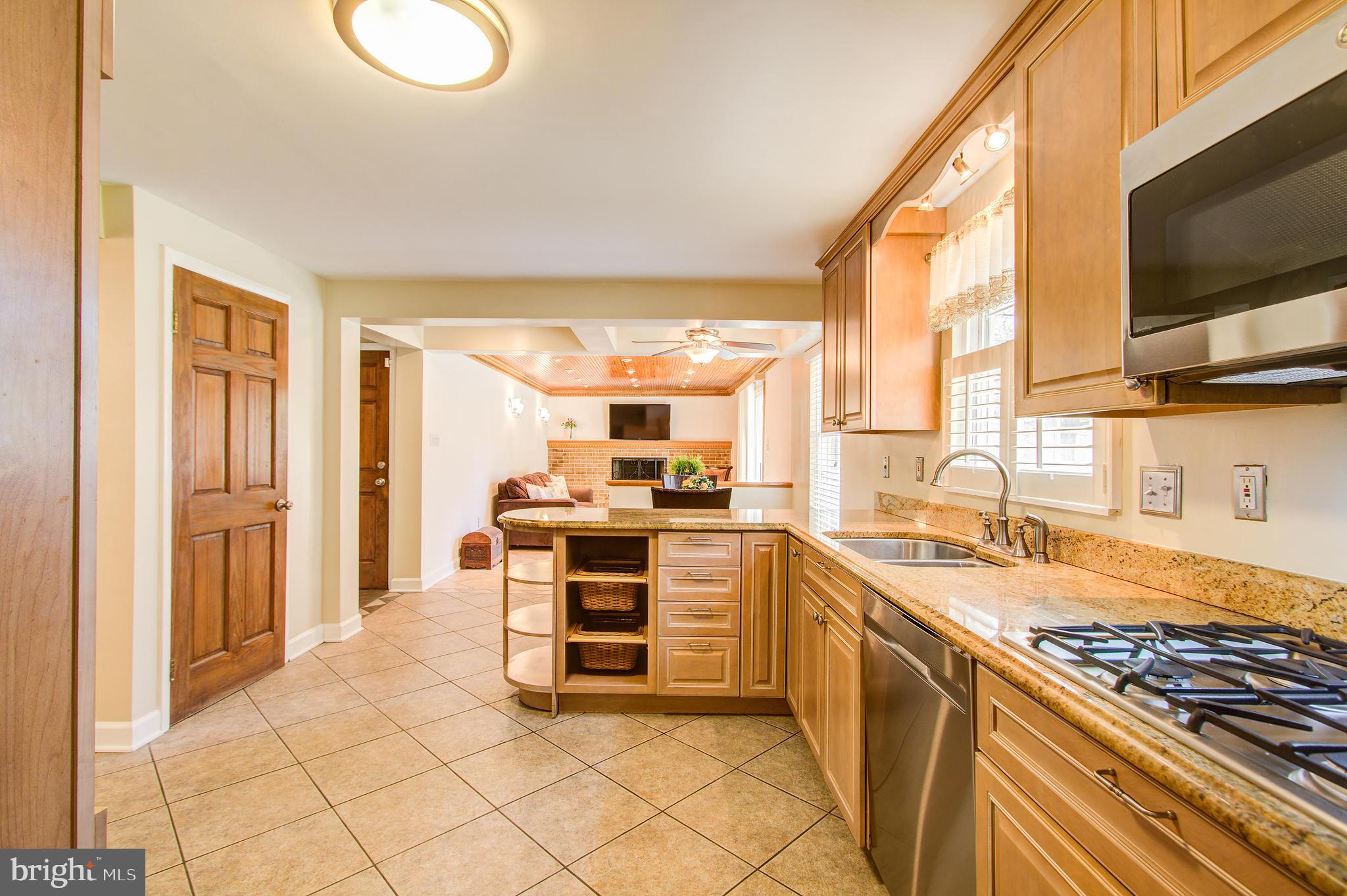 1413 Rainbow Drive Silver Spring, MD 20905 - Photo 13 of 50 a kitchen with stainless steel appliances granite countertop a stove and a sink