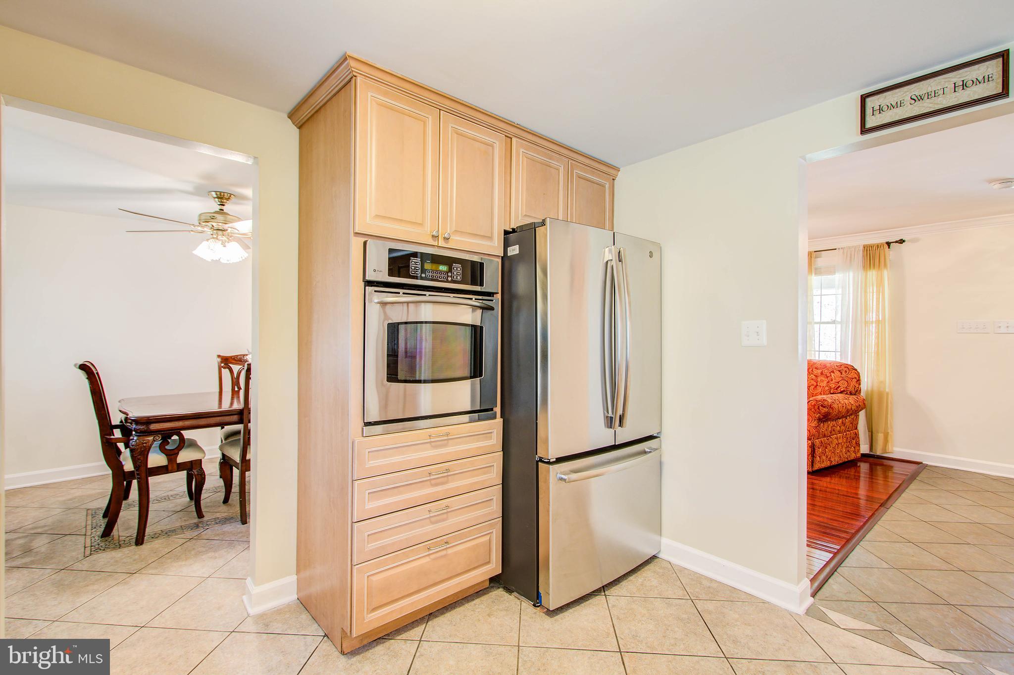 1413 Rainbow Drive Silver Spring, MD 20905 - Photo 14 of 50 a kitchen with stainless steel appliances a refrigerator and microwave