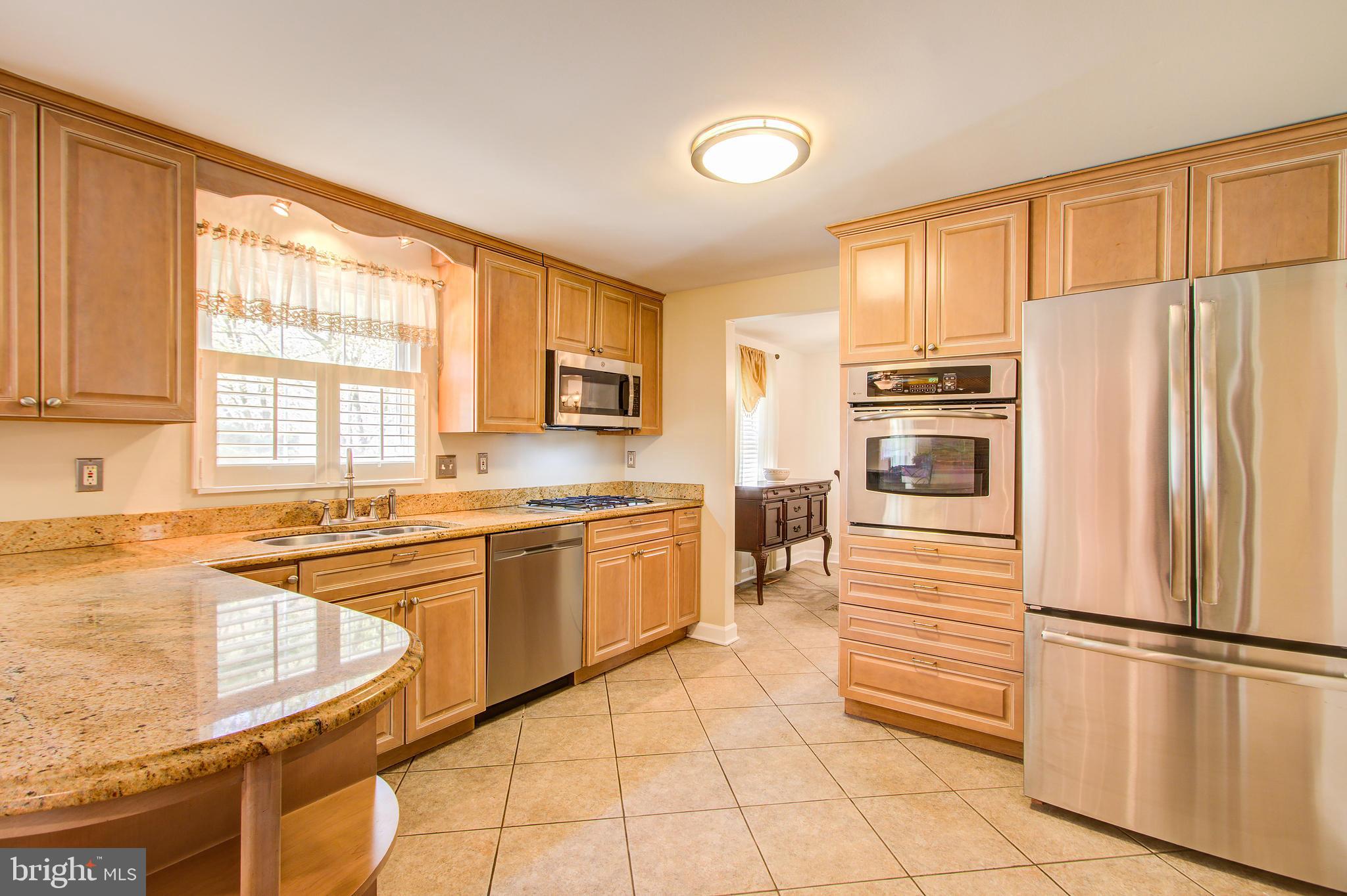 1413 Rainbow Drive Silver Spring, MD 20905 - Photo 15 of 50 a kitchen with stainless steel appliances granite countertop a refrigerator sink and cabinets