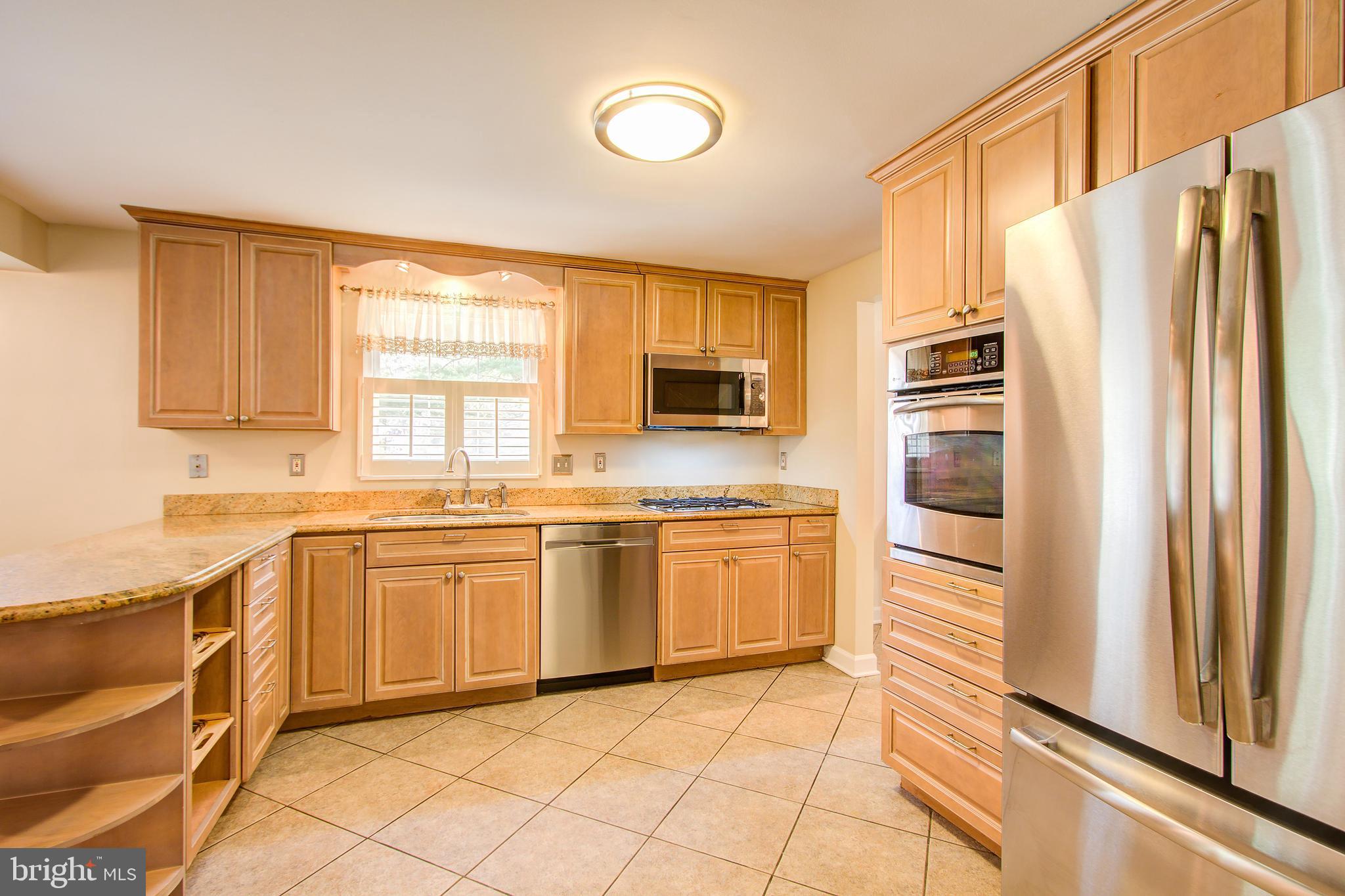 1413 Rainbow Drive Silver Spring, MD 20905 - Photo 16 of 50 a kitchen with stainless steel appliances granite countertop a refrigerator and a sink