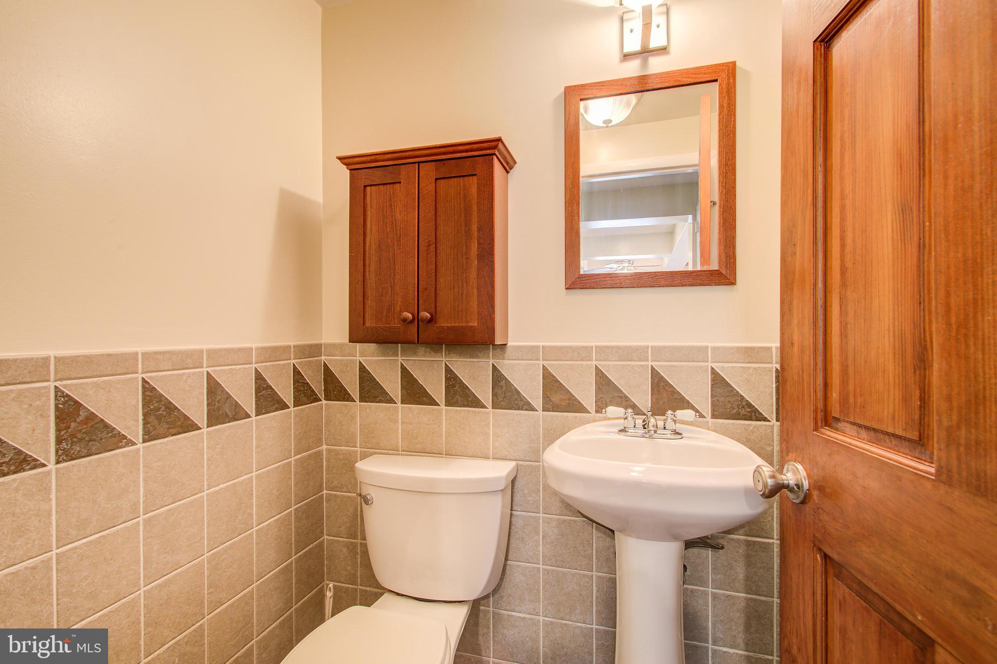 1413 Rainbow Drive Silver Spring, MD 20905 - Photo 21 of 50 a bathroom with a sink a toilet and mirror