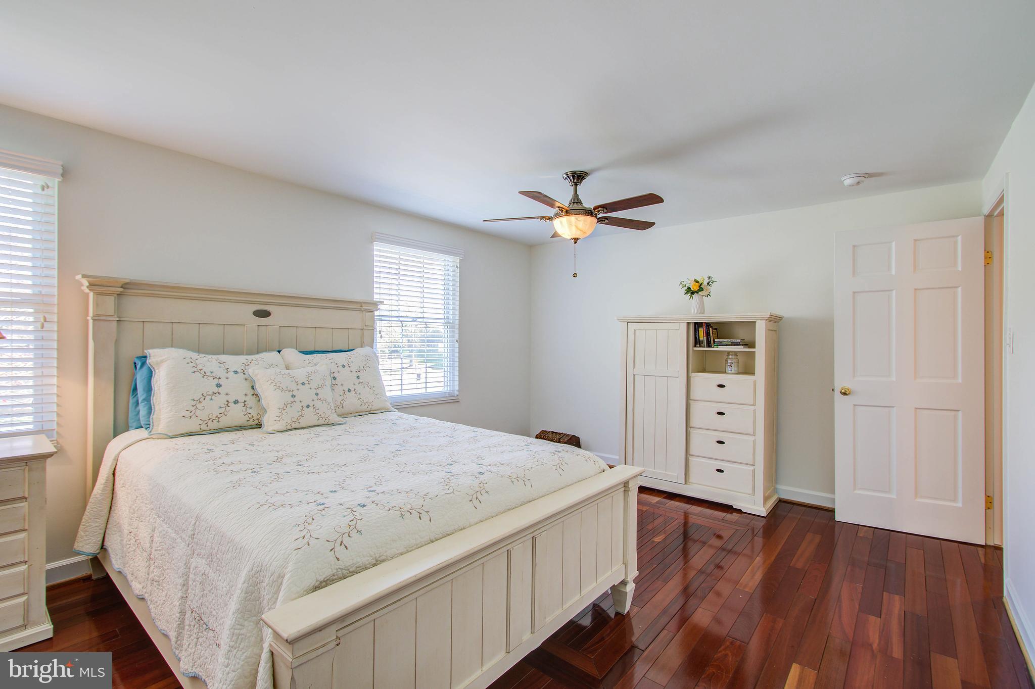 1413 Rainbow Drive Silver Spring, MD 20905 - Photo 24 of 50 a bedroom with a large bed and a chandelier