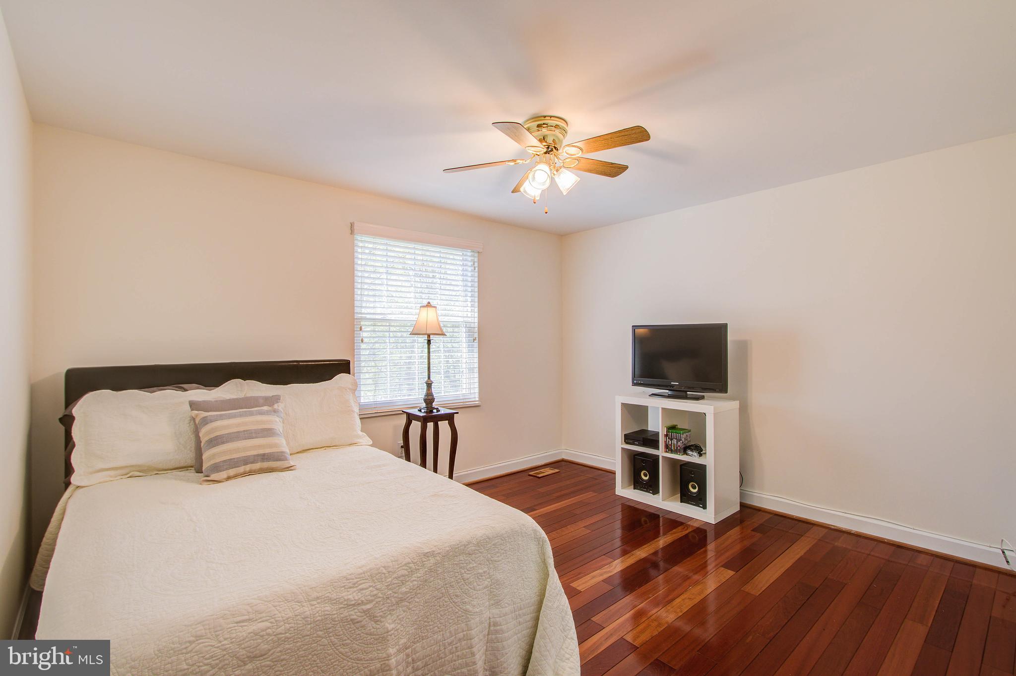 1413 Rainbow Drive Silver Spring, MD 20905 - Photo 25 of 50 a bedroom with a bed and a flat screen tv