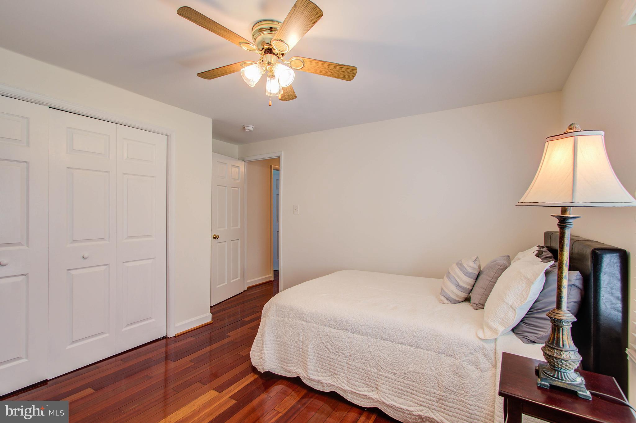 1413 Rainbow Drive Silver Spring, MD 20905 - Photo 26 of 50 a bedroom with a bed and a chandelier