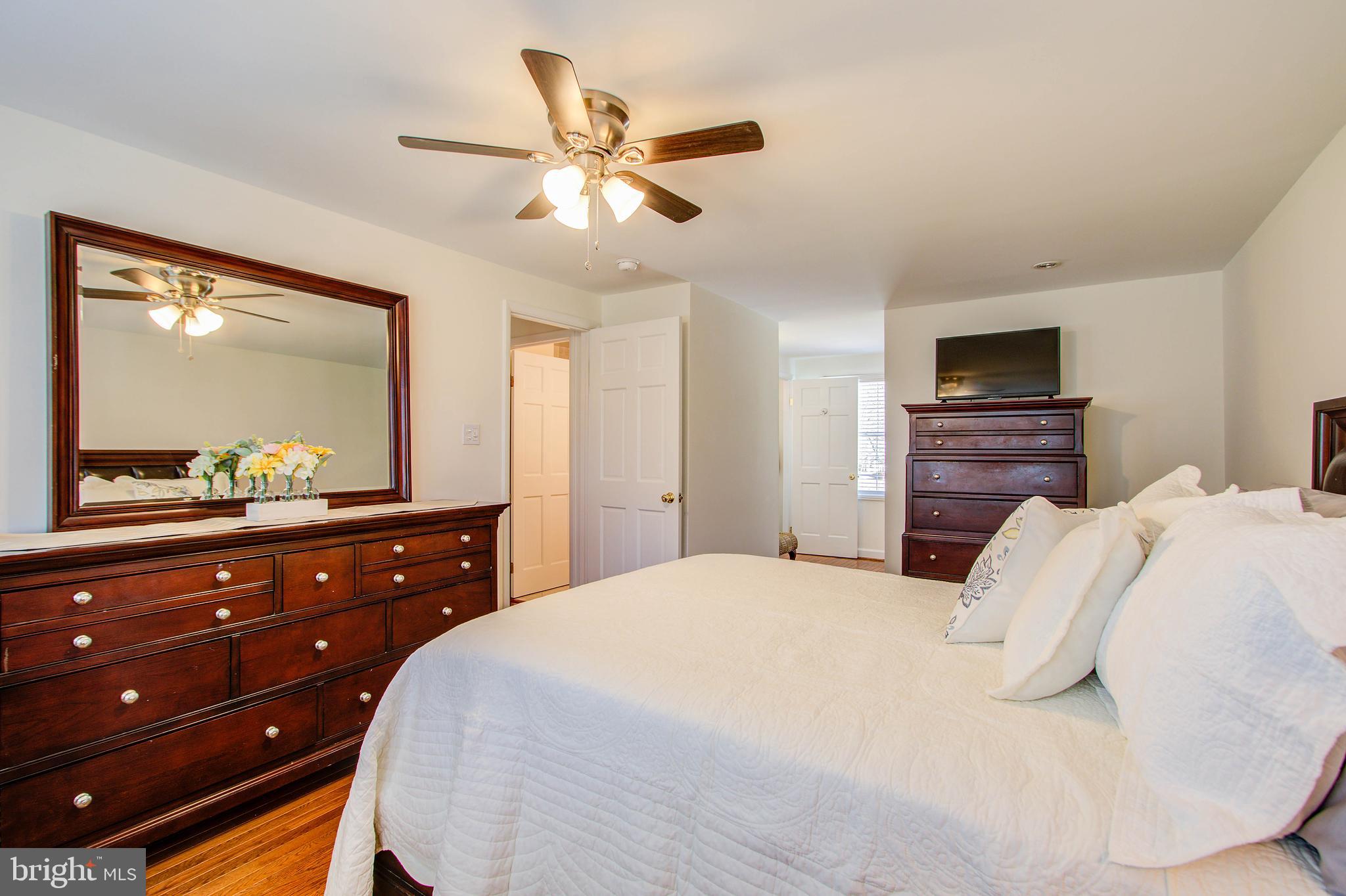 1413 Rainbow Drive Silver Spring, MD 20905 - Photo 28 of 50 a bedroom with a bed and a mirror on dresser
