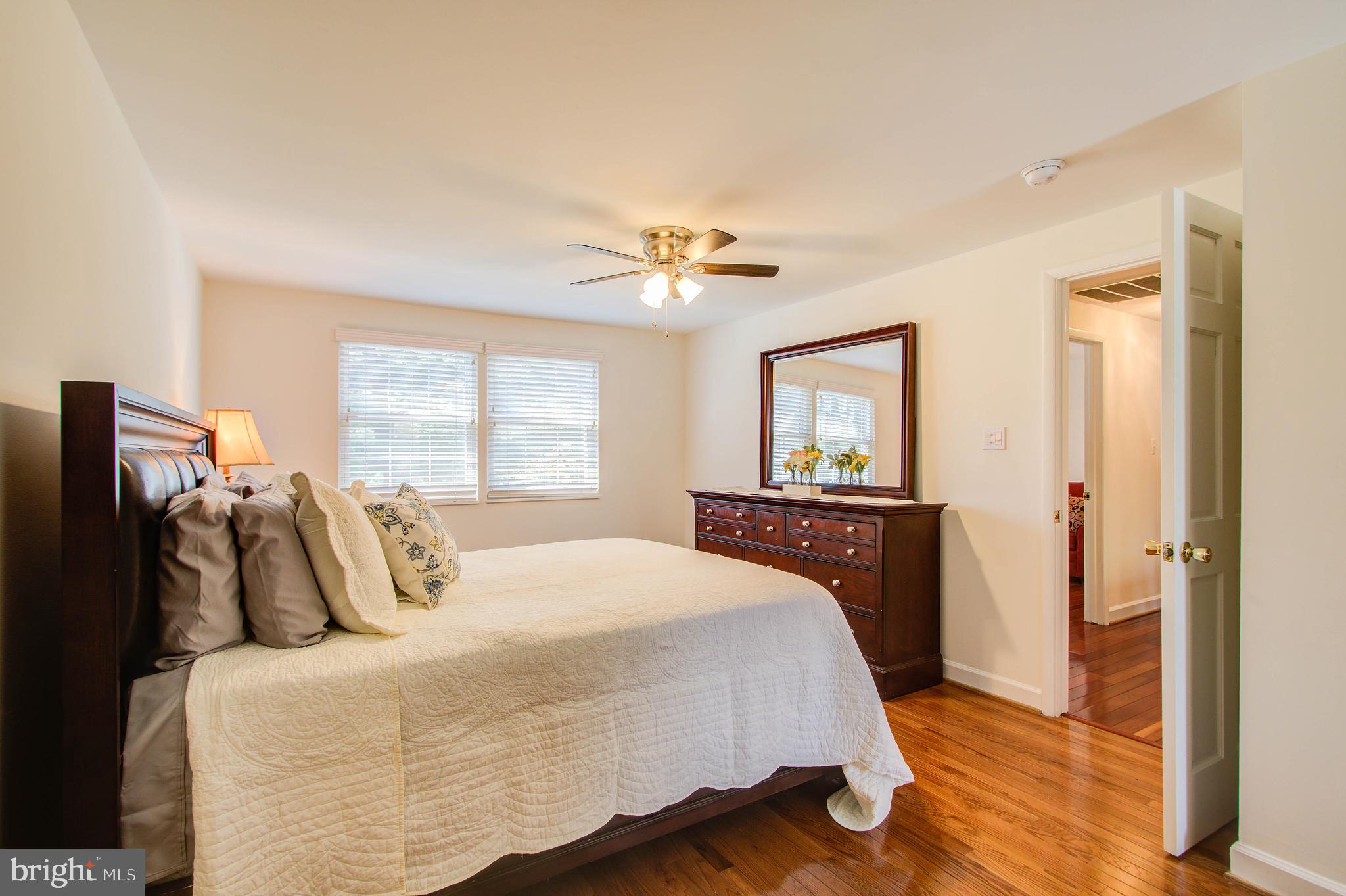 1413 Rainbow Drive Silver Spring, MD 20905 - Photo 29 of 50 a bedroom with a bed and a chandelier