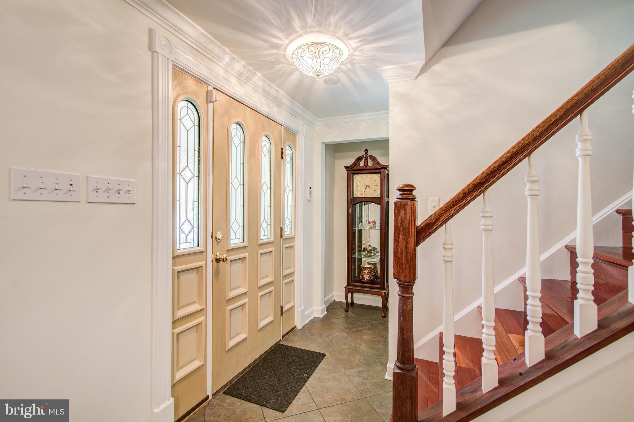 1413 Rainbow Drive Silver Spring, MD 20905 - Photo 7 of 50 a view of an entryway with wooden floor and stairs