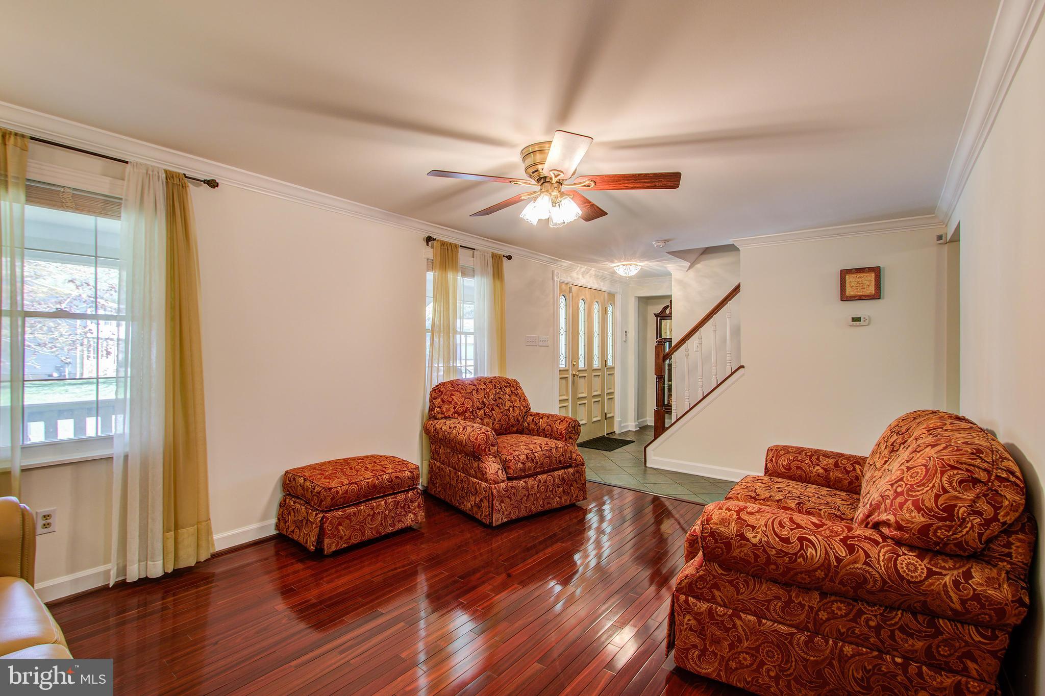 1413 Rainbow Drive Silver Spring, MD 20905 - Photo 9 of 50 a living room with furniture ceiling fan and a window