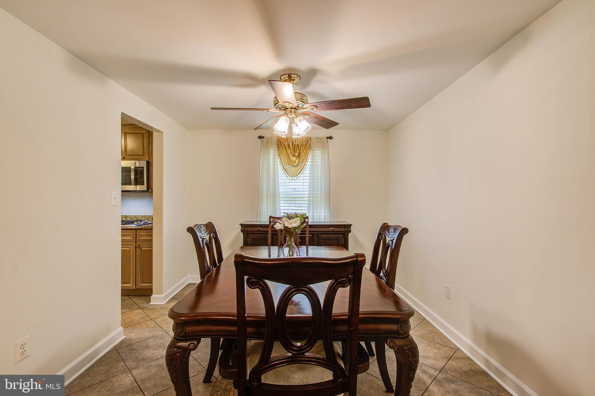 1413 Rainbow Drive Silver Spring, MD 20905 - Photo 10 of 50 a view of a dining room with furniture and a chandelier