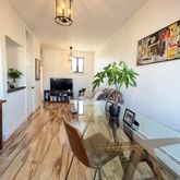 a dining room with furniture a chandelier and wooden floor