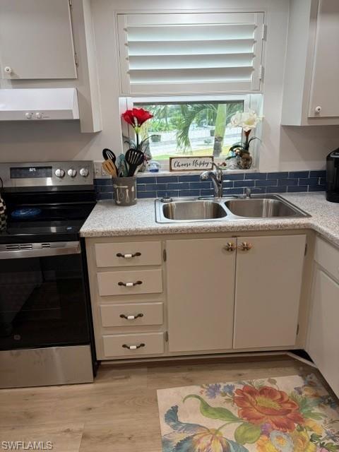 5 High Point Circle West, Unit 206 Naples, FL 34103 - Photo 36 of 39 a kitchen with a sink and cabinets
