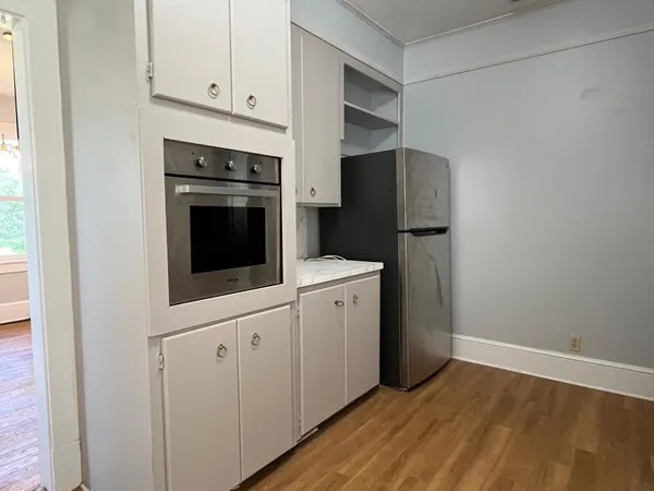 a kitchen with cabinets and steel appliances