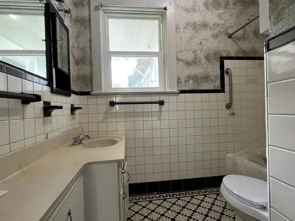 a bathroom with a sink toilet a mirror and shower