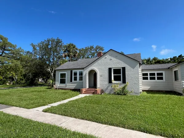 a front view of house with yard and green space